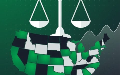 US map as stone mosaic tiles, some lit green, beneath balanced scales on a slate field