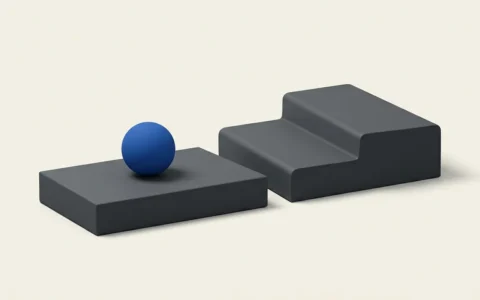 Illustration of a smooth blue sphere resting on a gray rectangular block next to a separate, taller stepped platform.